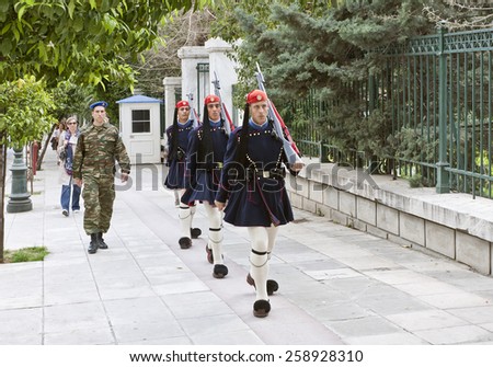ATHENS, GREECE ON APRIL 15. Guard on duty march up to the Parliament building at Syntagma on April 15, 2011 in Athens, Greece. Unidentified people on the sidewalk.