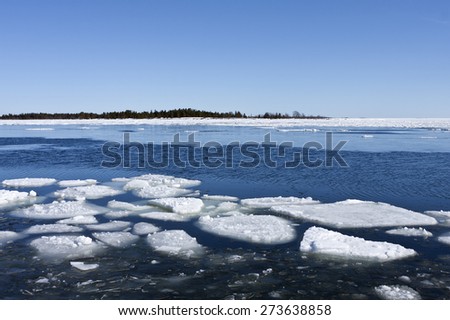 Shore of the Baltic Sea in March during the day, hours when the ice at sea breaks up. Sunny day by the sea.