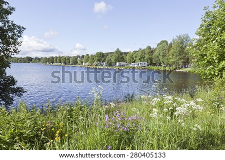 GREAT-LAKE, SWEDEN - JULY 03, 2012: View of a camping area, caravans and campers on July 03, 2012 by the Great-Lake, Sweden.