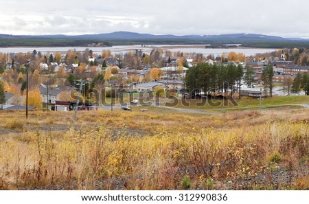 MALA, SWEDEN ON OCTOBER 09. View of a community, buildings up north on October 09, 2013 in Mala, Sweden. Colorful downhill slope this side, lake in the background. Overcast sky.