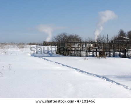 View of old wooden country fence on winter sunny day