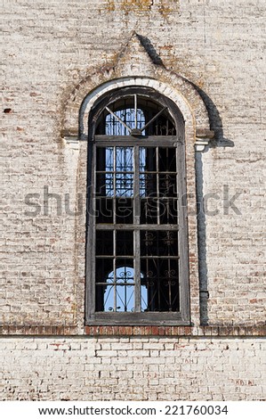 Big window of old destroyed orthodox church in village Igoshevo, Vologda region, Russia