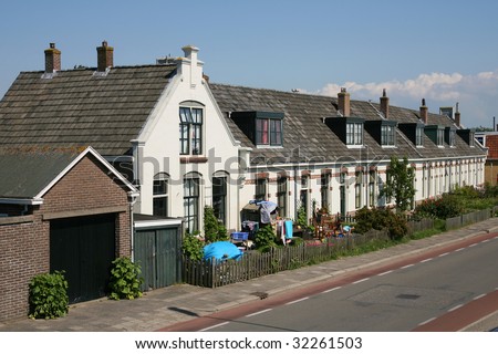 Street in Harlingen(Holland) with a row of houses painted white