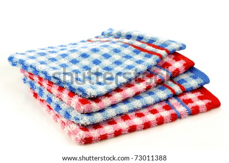stacked colorful checkered bathroom  wash cloths on a white background