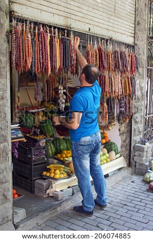 TBILISI, GEORGIA - JUNE 28, 2014: Man selling Georgian sweets at a typical convenience store on June 28, 2014 in Tbilisi, Georgia, East Europe