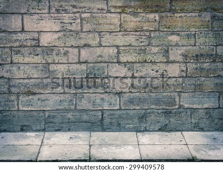 Grunge room interior with stone wall and tiled floor