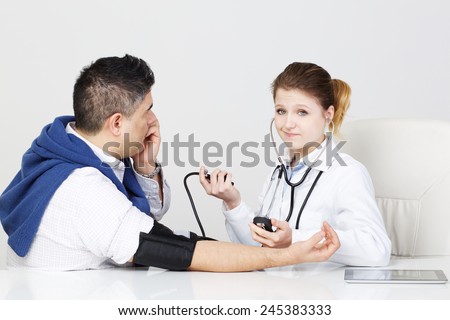 Doctor Checking Blood Pressure of a Woman