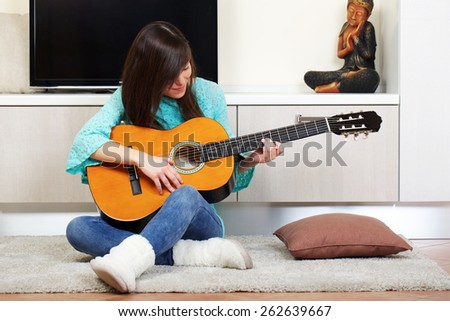young woman play guitar