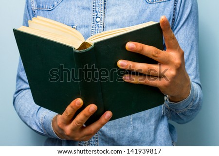 Man reading old heavy book.