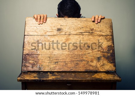 Man looking inside old school desk