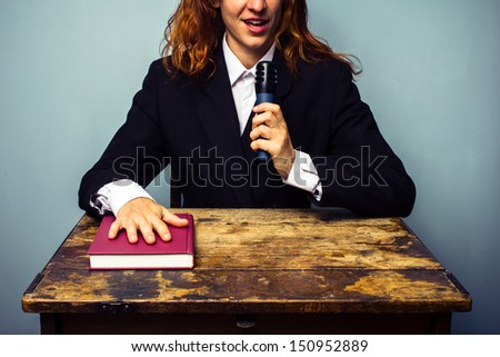 Woman in suit talking about book