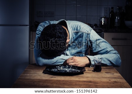 Sad man alone in his kitchen