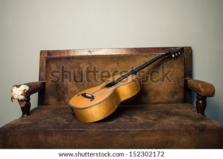 Classic guitar on old sofa