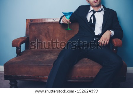 Relaxed businessman drinking after work