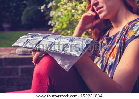 Young woman with cold pack on injured hand