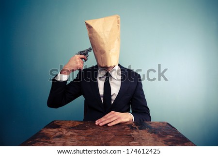Businessman with bag over head committing suicide