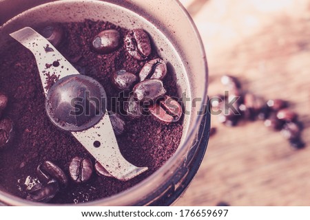 Close up on an electric coffee grinder with beans