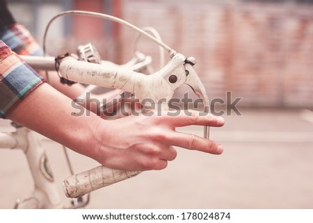 Young woman is riding a bike, closeup on her hands