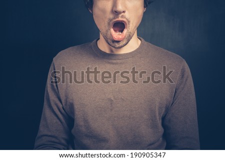 Surprised young man with his mouth open
