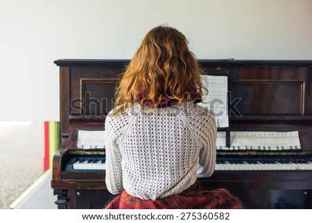A young woman is playing the piano