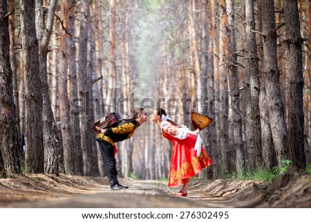 Beautiful woman and man in a russian national dress