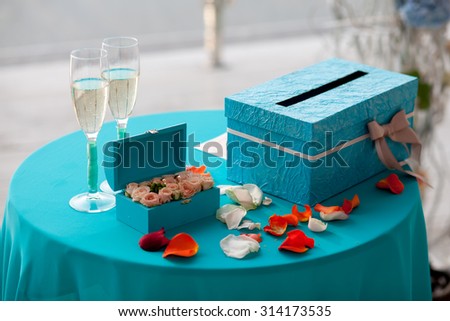 Beautiful wedding rings, gift box and wine glasses