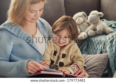 Mother and child reading and writing on the Sofa