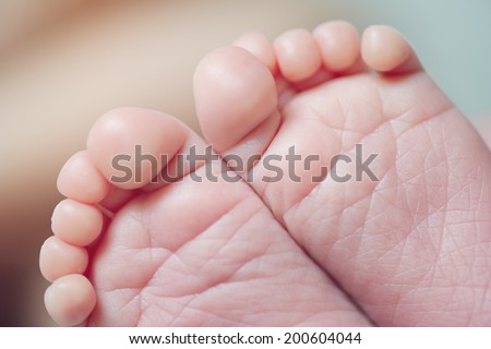 Small little feet of newborn
