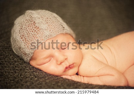 Portrait of Newborn Baby Sleeping in Hand-made Hat - close portrait