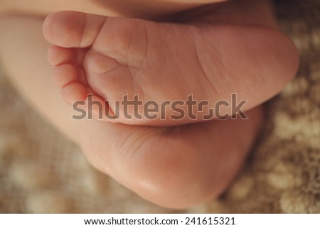 Small delicate little feet and toes of child