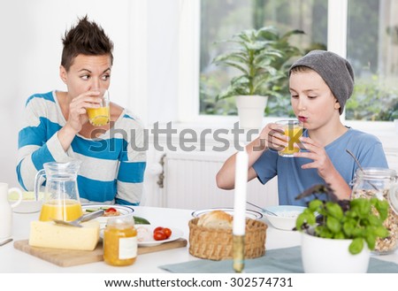 Mother and son having breakfast together in the morning