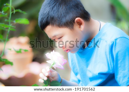 Asian boys Smelling the flowers