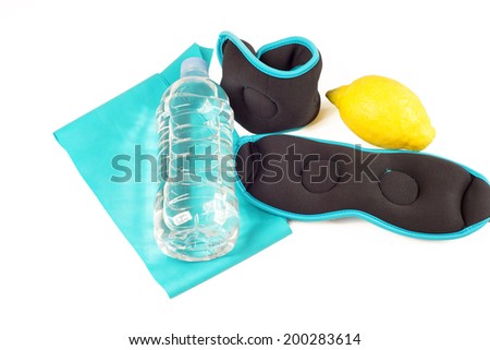 Ankle weights, band, lemon and bottle with water, isolated