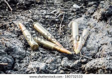 five rifle strewn bullet on the clay