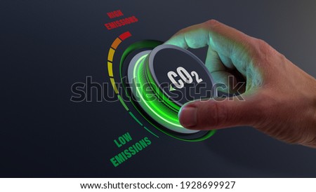Lower CO2 emissions to limit global warming and climate change. Concept with manager hand turning knob to reduce levels of CO2. New technology to decarbonize industry, energy and transport Stockfoto © 