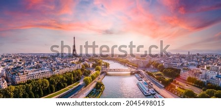Paris aerial panorama with river Seine and Eiffel tower, France. Romantic summer holidays vacation destination. Panoramic view above historical Parisian buildings and landmarks with sunset sky