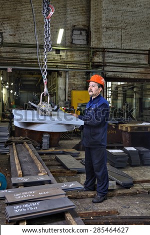 St. Petersburg, Russia - May 21, 2015: The operator lifting device, lift loads using lifting magnet, mechanical workshop, metal structures plant.