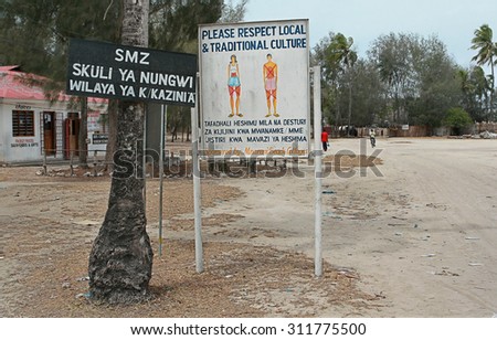 Zanzibar, Tanzania - February 18, 2008: Information board near beach  with inscription, please respect local and traditional culture, image with strikethrough parts of  body that can not uncover.