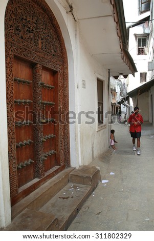 Stone Town, Zanzibar, Tanzania - February 16, 2008: Vintage traditional carved wooden doors in the houses on the narrow streets of old town.