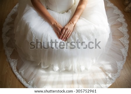 sitting bride with her hands