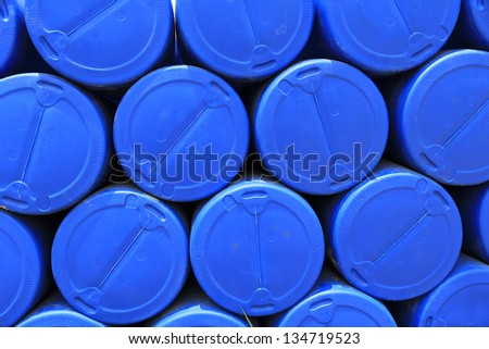 big pile of stacked blue barrels