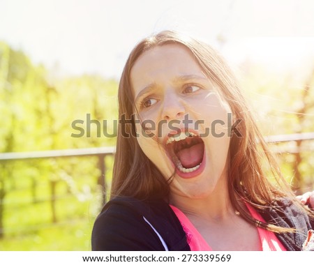 young girl screaming out of pain in sunshine weather