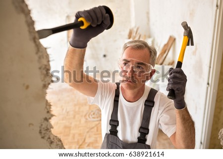 Worker senior builder demolish wall with tool Stock foto © 