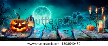 Jack O’ Lantern On Table In Spooky Night - Halloween With Full Moon
