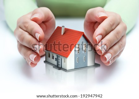 house protected of woman hands - protect and insurance real estate concept