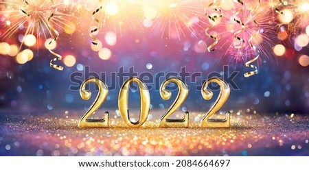 2022 New Year Celebration - Golden Numbers On Glitter With Fireworks And Abstract Defocused Lights