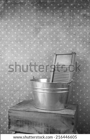 old fashioned laundry equipment, washboard and tub in black and white vertical orientation