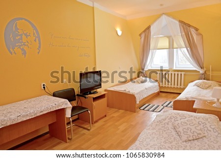 The triple hotel room with a portrait of the Russian writer L.N. Tolstoy on a wall Stock fotó © 