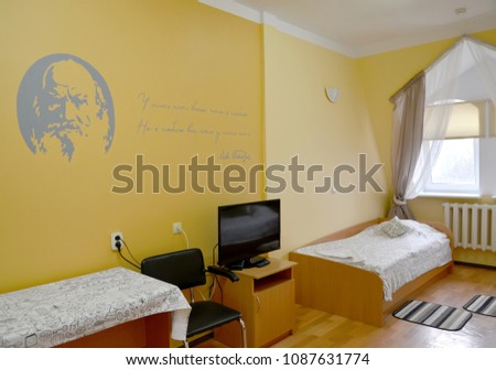 Fragment of an interior of the hotel room with a portrait of the Russian writer L.N. Tolstoy on a wall Stock fotó © 