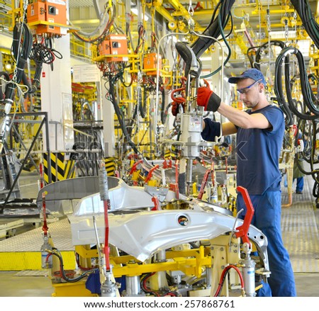 KALININGRAD, RUSSIA - SEPTEMBER 16, 2014: Welding of a body of the car device of spot contact welding. Automobile production